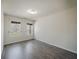 Bright bedroom featuring wood-look flooring and two large windows at 2924 Weyhill Trl, Buford, GA 30519