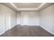 Spacious bedroom featuring modern floors, ample lighting, and three doors at 2924 Weyhill Trl, Buford, GA 30519