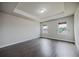 Comfortable bedroom with hardwood floors, decorative ceiling, and view windows at 2924 Weyhill Trl, Buford, GA 30519