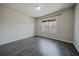 Bedroom with wood-look flooring and window with wood blinds at 2924 Weyhill Trl, Buford, GA 30519