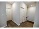 Hallway with wood-look floors, showing the staircase and white door frames at 2924 Weyhill Trl, Buford, GA 30519