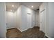 Hallway with wood-look floors and white doors, offering access to various rooms at 2924 Weyhill Trl, Buford, GA 30519