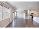 Sun-filled living area with hardwood floors and staircase adjacent to a kitchen at 2924 Weyhill Trl, Buford, GA 30519