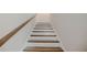Classic staircase with wooden handrail and steps leading to the upper level of the home at 2924 Weyhill Trl, Buford, GA 30519
