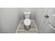 Small water closet with a standard white toilet and gray stone-look flooring at 2924 Weyhill Trl, Buford, GA 30519