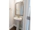 Cozy powder room featuring a pedestal sink, mirror, and towel ring, providing a convenient space at 2924 Weyhill Trl, Buford, GA 30519