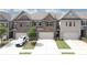 Charming brick townhomes with attached garages and well-manicured lawns present a welcoming curb appeal at 2924 Weyhill Trl, Buford, GA 30519