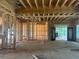 Unfinished living room under construction with stairs, a fireplace and large windows at 3425 Dr Bramblett Rd, Cumming, GA 30028
