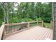 Inviting back deck overlooking a spacious, fenced backyard with lush greenery and a charming playset for outdoor enjoyment at 399 Towler Drs, Loganville, GA 30052