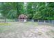 Backyard with a storage shed, swing set, and fenced perimeter, offering practical storage and outdoor recreation space at 399 Towler Drs, Loganville, GA 30052