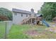 Spacious backyard features a playset, fenced perimeter, and lush greenery, perfect for outdoor activities and Gathering enjoyment at 399 Towler Drs, Loganville, GA 30052