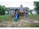 Backyard with a playset, swing set, and fenced perimeter, creating a safe and fun outdoor environment for  at 399 Towler Drs, Loganville, GA 30052