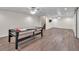 Finished basement with a recreation area featuring an air hockey table and vinyl plank flooring at 399 Towler Drs, Loganville, GA 30052