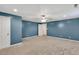 Spacious basement featuring carpeting, a ceiling fan, and access to additional rooms at 399 Towler Drs, Loganville, GA 30052