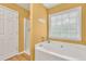 This well-lit bathroom has a stand-up shower and a large soaking tub at 399 Towler Drs, Loganville, GA 30052