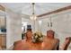 Well-lit dining room showcasing a stylish chandelier and easy access to kitchen at 399 Towler Drs, Loganville, GA 30052