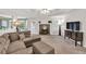 Comfortable living room features a fireplace, tray ceiling, and ample natural light from backyard at 399 Towler Drs, Loganville, GA 30052