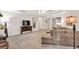 Cozy living room showcasing neutral tones, plush seating, and seamless flow to dining area at 399 Towler Drs, Loganville, GA 30052