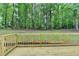 View of a back deck and the tree-filled backyard at 545 Woodrow Dr, Lawrenceville, GA 30043