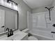 The bathroom includes a shower-tub combo, modern sink and vanity, and neutral paint at 545 Woodrow Dr, Lawrenceville, GA 30043