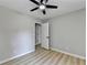 This bedroom features a ceiling fan and white painted door at 545 Woodrow Dr, Lawrenceville, GA 30043