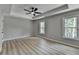 This bedroom features a ceiling fan, wood floors, recessed ceiling and large windows at 545 Woodrow Dr, Lawrenceville, GA 30043