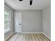 Cozy bedroom featuring a window and white painted door at 545 Woodrow Dr, Lawrenceville, GA 30043