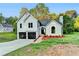 Charming two-story home with a well-manicured lawn, black garage doors, and inviting front entrance at 545 Woodrow Dr, Lawrenceville, GA 30043