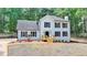 Beautiful two-story home with black shutters, a cozy porch, and a well-maintained lawn at 545 Woodrow Dr, Lawrenceville, GA 30043