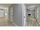 Bright hallway with modern flooring, white doors, and a glimpse into the inviting living room with fireplace at 545 Woodrow Dr, Lawrenceville, GA 30043