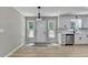 Bright kitchen featuring white cabinets, modern appliances, and a view of the backyard and dining area at 545 Woodrow Dr, Lawrenceville, GA 30043