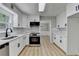 Contemporary kitchen featuring white cabinets, stainless steel appliances, and modern countertops at 545 Woodrow Dr, Lawrenceville, GA 30043
