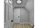 Bright laundry room features light wood floors, white door, and flush mount ceiling light at 545 Woodrow Dr, Lawrenceville, GA 30043