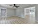 Inviting living room featuring modern flooring, neutral walls, and a view into the elegant dining area at 545 Woodrow Dr, Lawrenceville, GA 30043