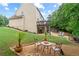 Well-maintained backyard featuring a patio, lush lawn, and mature trees at 155 Edgewater Trl, Canton, GA 30115