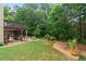 Private backyard with mature trees, a multi-level deck, and comfortable patio seating at 155 Edgewater Trl, Canton, GA 30115