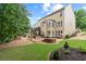 Expansive backyard featuring a patio, lush landscaping, and a charming outdoor seating area at 155 Edgewater Trl, Canton, GA 30115