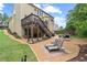 Spacious backyard with a two-story deck, lounge chairs, and manicured landscaping at 155 Edgewater Trl, Canton, GA 30115