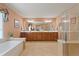 Spacious primary bath features double vanity, soaking tub, walk-in shower, and tile flooring, offering relaxation at 155 Edgewater Trl, Canton, GA 30115