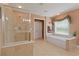 Serene bathroom with separate shower and soaking tub, neutral tile, and a window for natural light at 155 Edgewater Trl, Canton, GA 30115