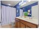 Bright bathroom featuring a double sink vanity and a shower with white curtain at 155 Edgewater Trl, Canton, GA 30115
