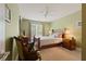 Comfortable bedroom features neutral carpet, soft green walls, ceiling fan, and windows providing plenty of natural light at 155 Edgewater Trl, Canton, GA 30115