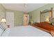 Charming bedroom featuring neutral carpet, soothing green walls, and a ceiling fan for added comfort and style at 155 Edgewater Trl, Canton, GA 30115