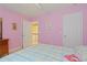 Vibrant pink bedroom features carpeted floors, a comfortable bed, ample natural light, and stylish decor at 155 Edgewater Trl, Canton, GA 30115