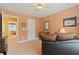 Cozy bedroom with a comfortable seating area, dresser and open doorway to laundry room at 155 Edgewater Trl, Canton, GA 30115