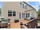 Spacious backyard deck featuring outdoor seating, dining area, and access to the lush green lawn at 155 Edgewater Trl, Canton, GA 30115