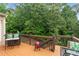 Cozy wooden deck with scenic views, grilling area, outdoor seating, and peaceful treetop vistas at 155 Edgewater Trl, Canton, GA 30115