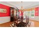 Bright dining room features hardwood floors, red walls, and a china cabinet at 155 Edgewater Trl, Canton, GA 30115