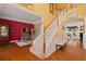 Staircase with a wood handrail in a brightly lit, two-story foyer at 155 Edgewater Trl, Canton, GA 30115