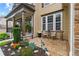 Inviting front porch with stone accents, seating area and lush garden at 155 Edgewater Trl, Canton, GA 30115